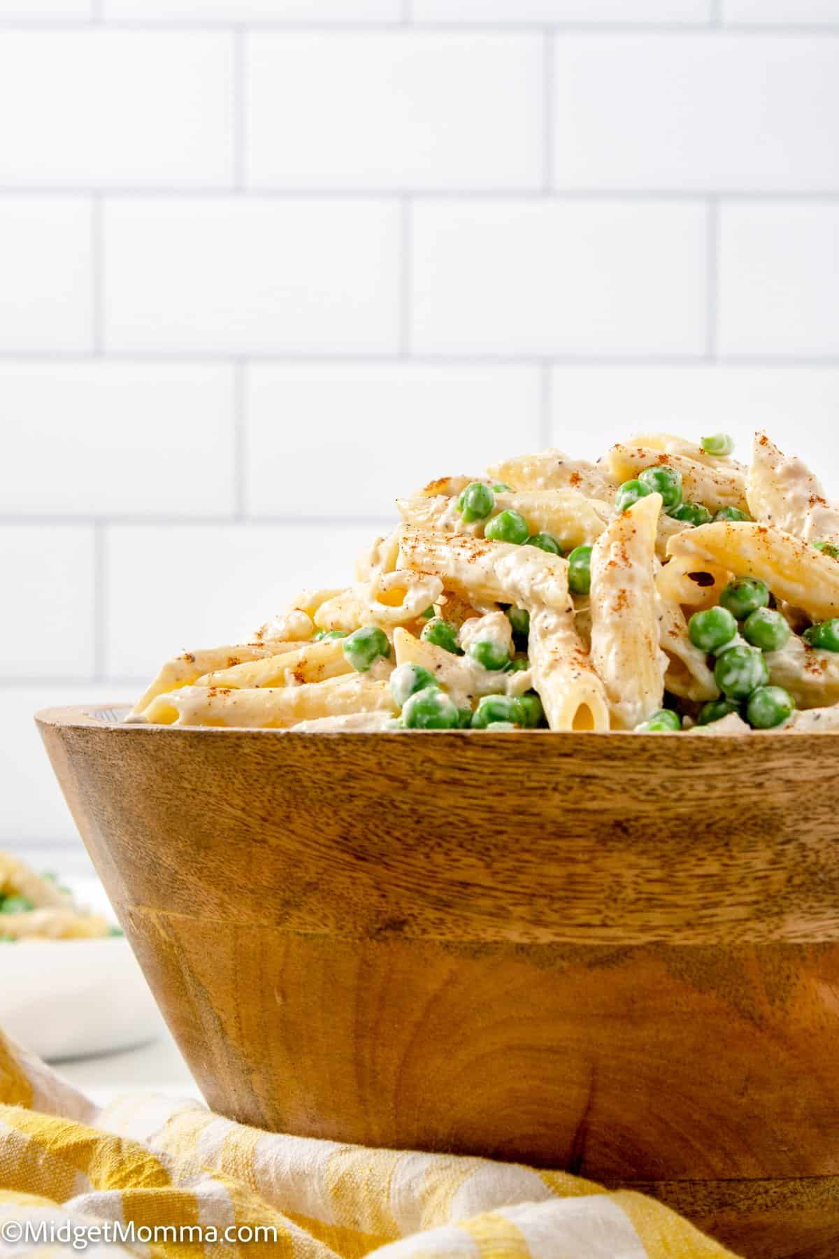 side view of tuna pasta salad in a wooden serving bowl