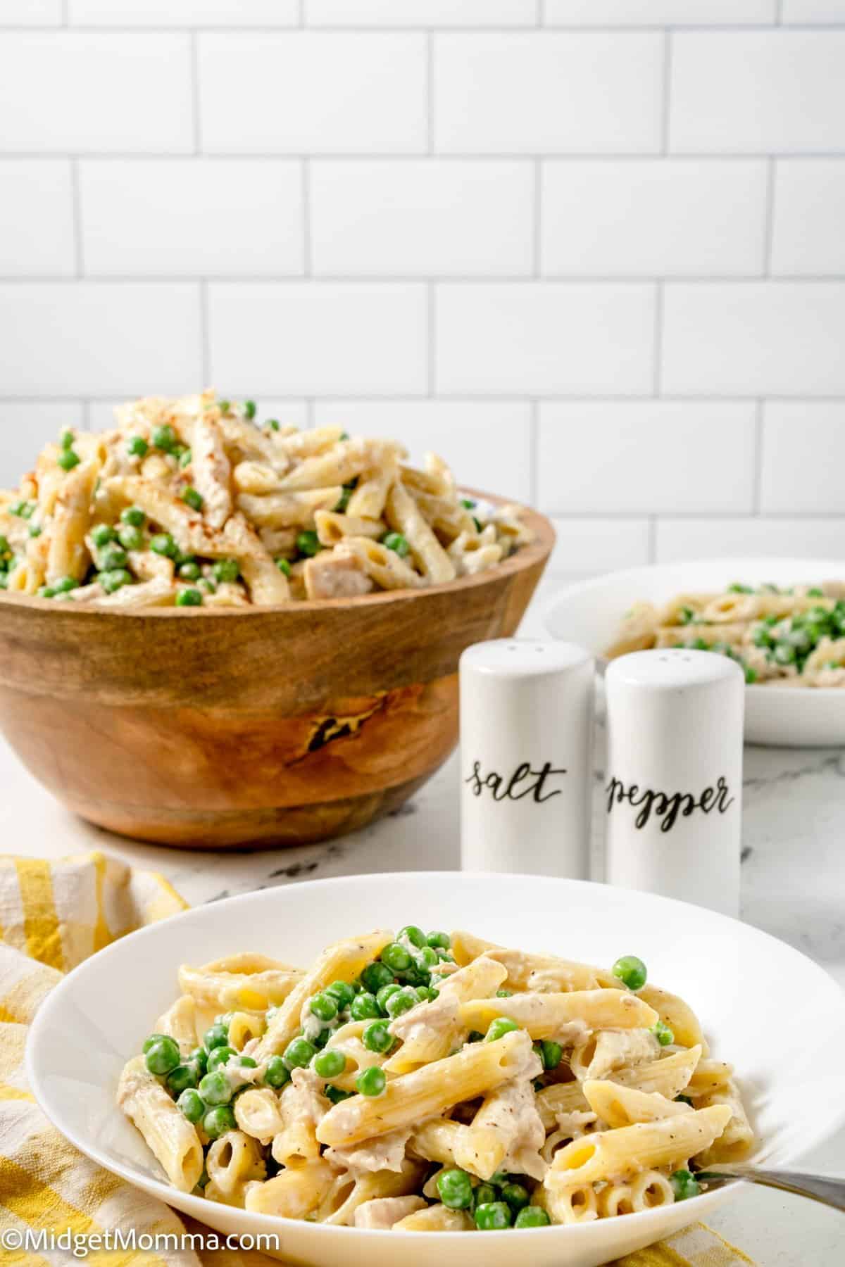 tuna pasta salad served on a plate with the serving bowl in the background