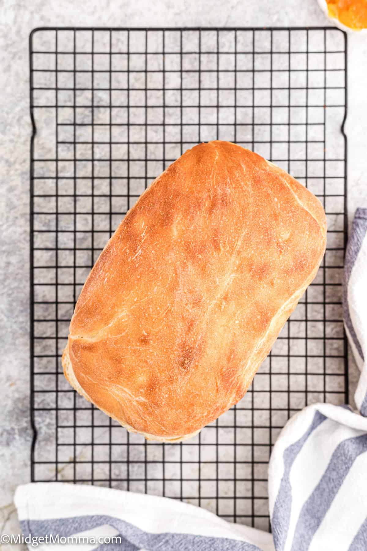 overhead photo of loaf of white bread on a cooling rack