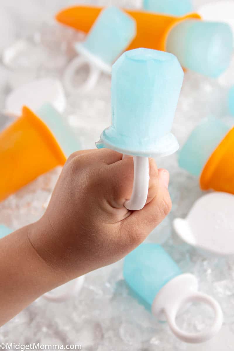 How to Make Homemade Pedialyte Popsicles - Child's hand holding a homemade pedialyte popsicle