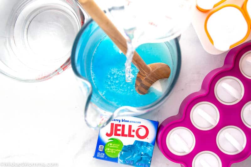 water being added to sugar, salt and Jell-o mix to make homemade pedialyte