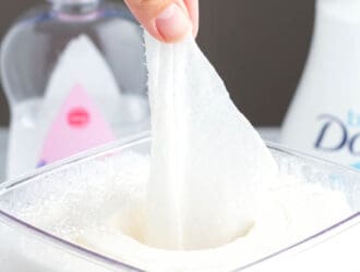 Homemade baby wipes in a container being pulled out