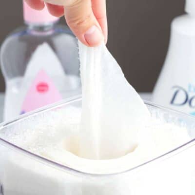 Homemade baby wipes in a container being pulled out