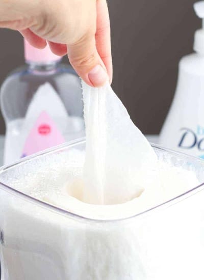 Homemade baby wipes in a container being pulled out