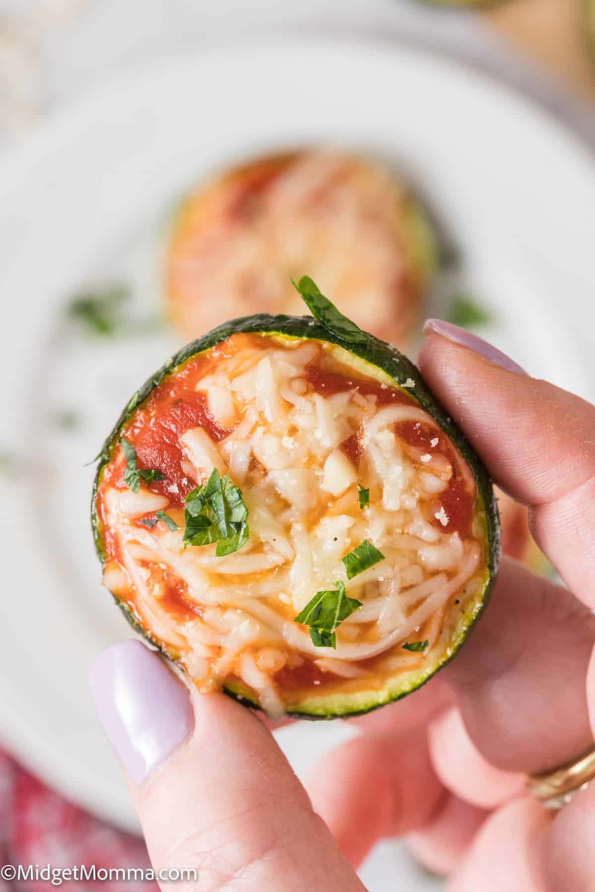 hand holding a Easy Zucchini Pizza Bite