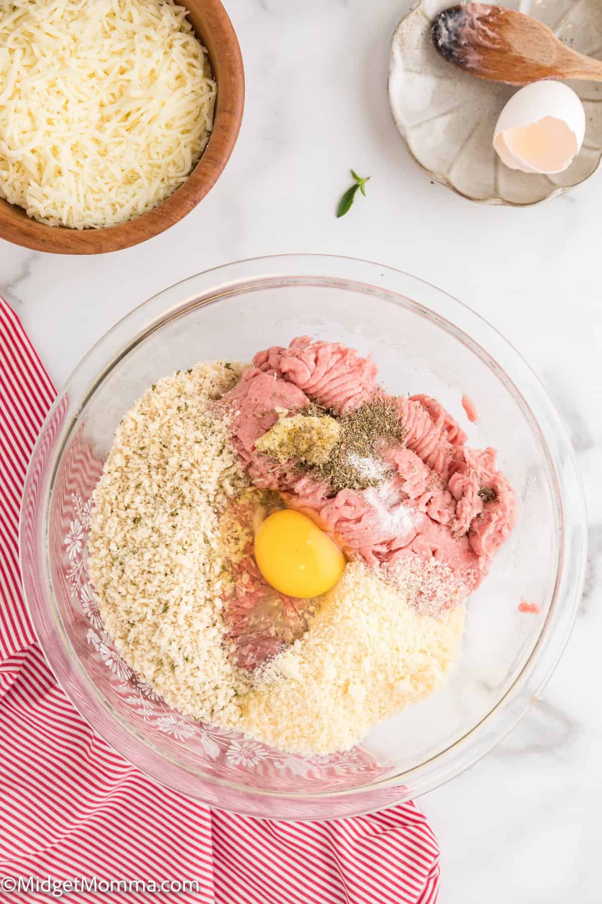 meatballs ingredients being mixed in a mixing bowl 