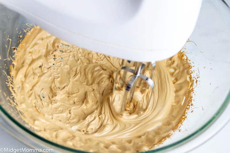 instant coffee, water and sugar being whipped in a bowl