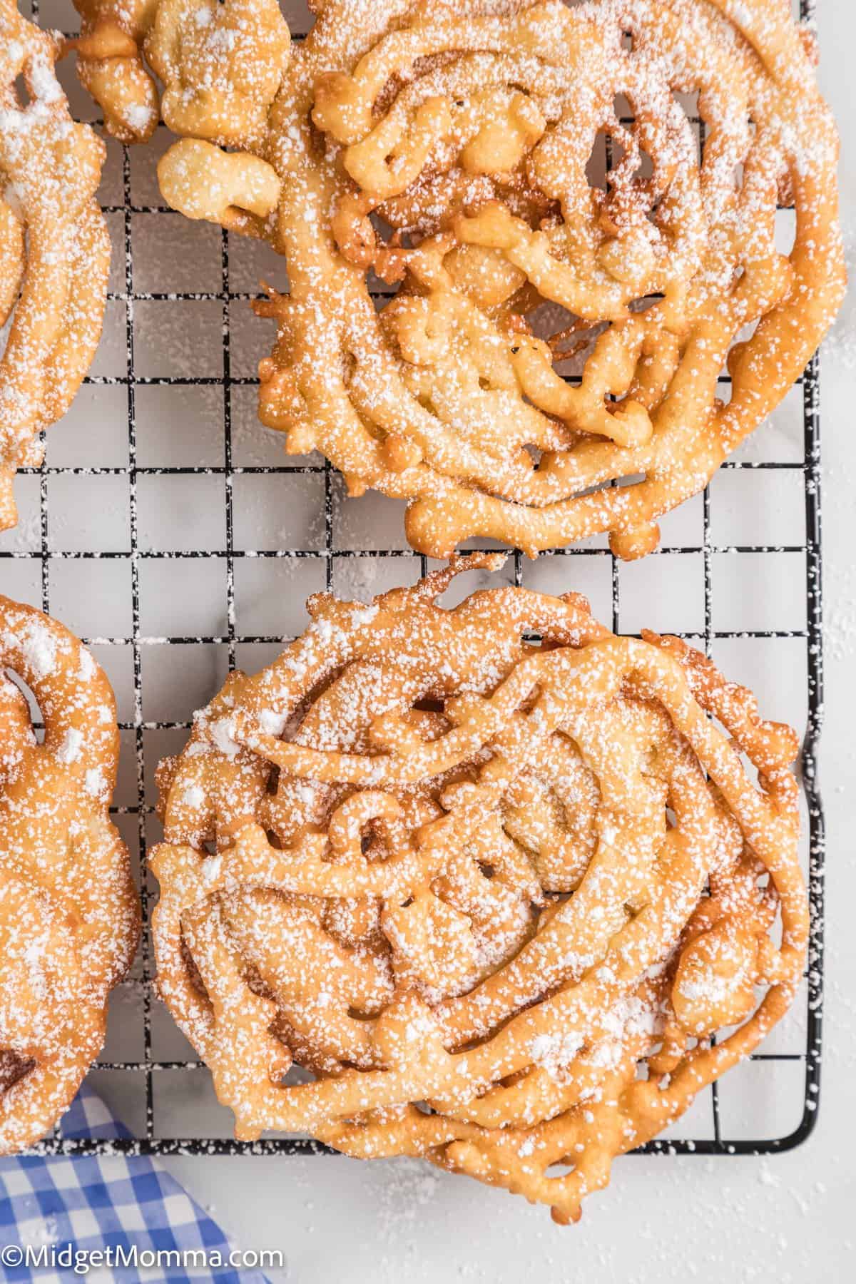 close up photo of Homemade Funnel Cakes on a wire rack