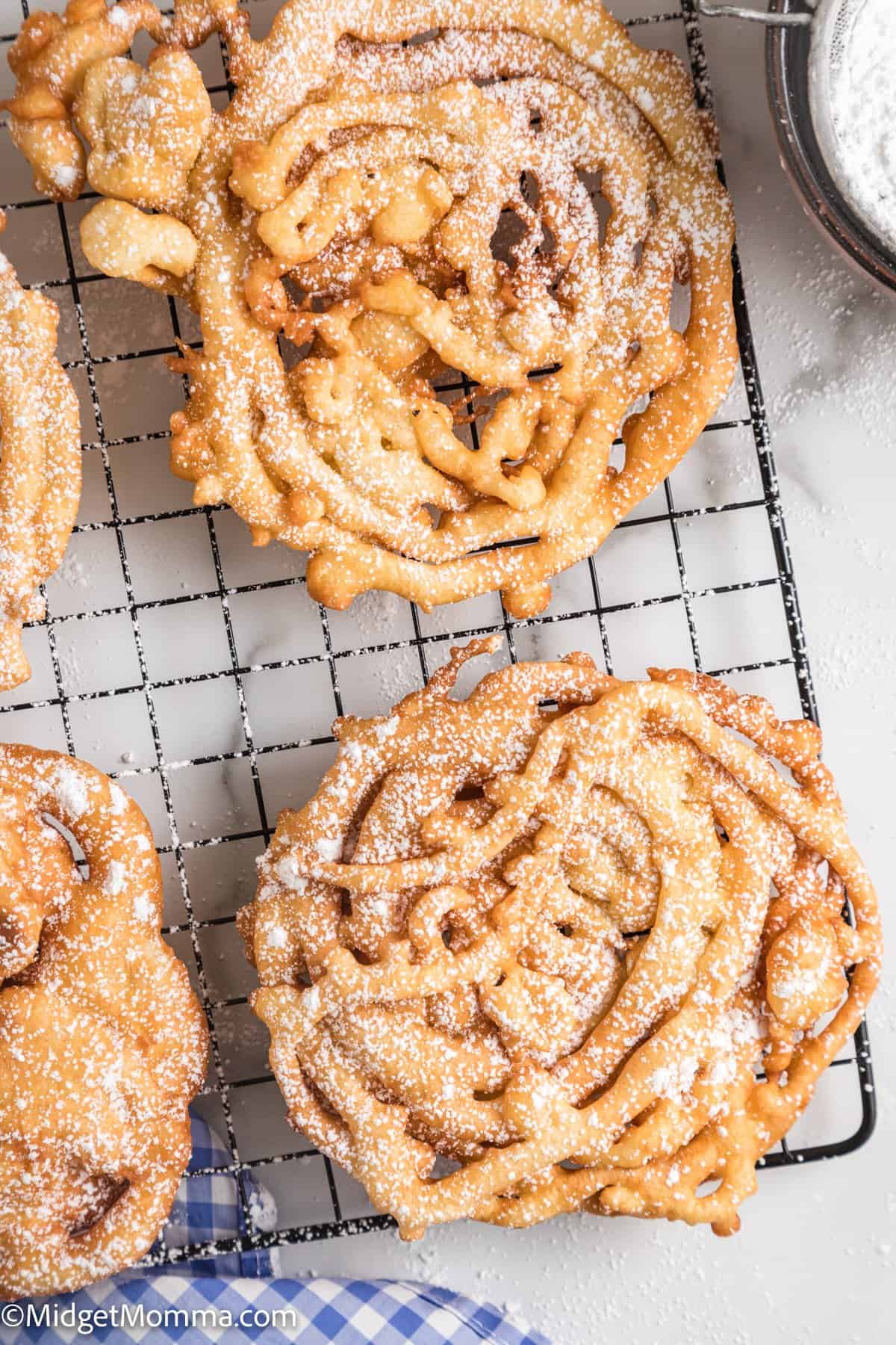 overhead photo of Homemade Funnel Cakes on a wire rack 