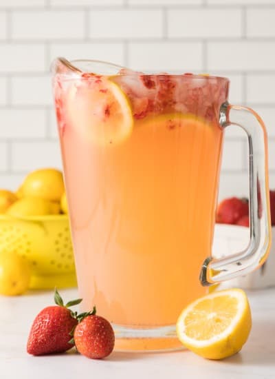 pitcher full of fresh made strawberry lemonade