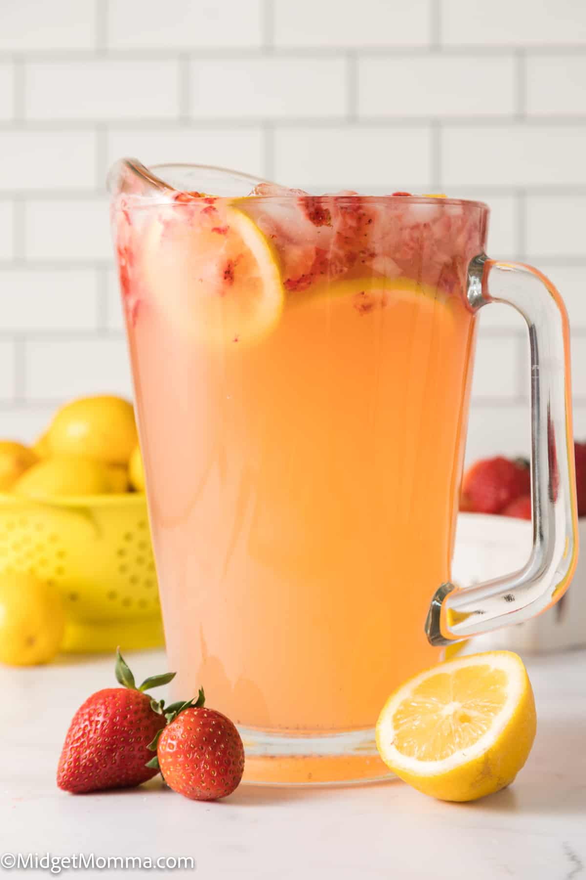pitcher full of fresh made strawberry lemonade