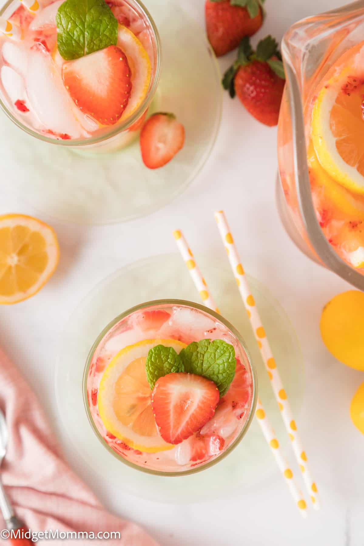 overhead photo of Homemade Strawberry Lemonade Recipe in a glass with fresh strawberries and mint leaves