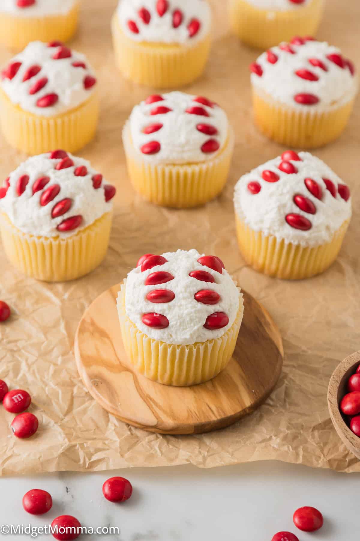 Baseball cupcakes with red and white frosting and M&Ms.