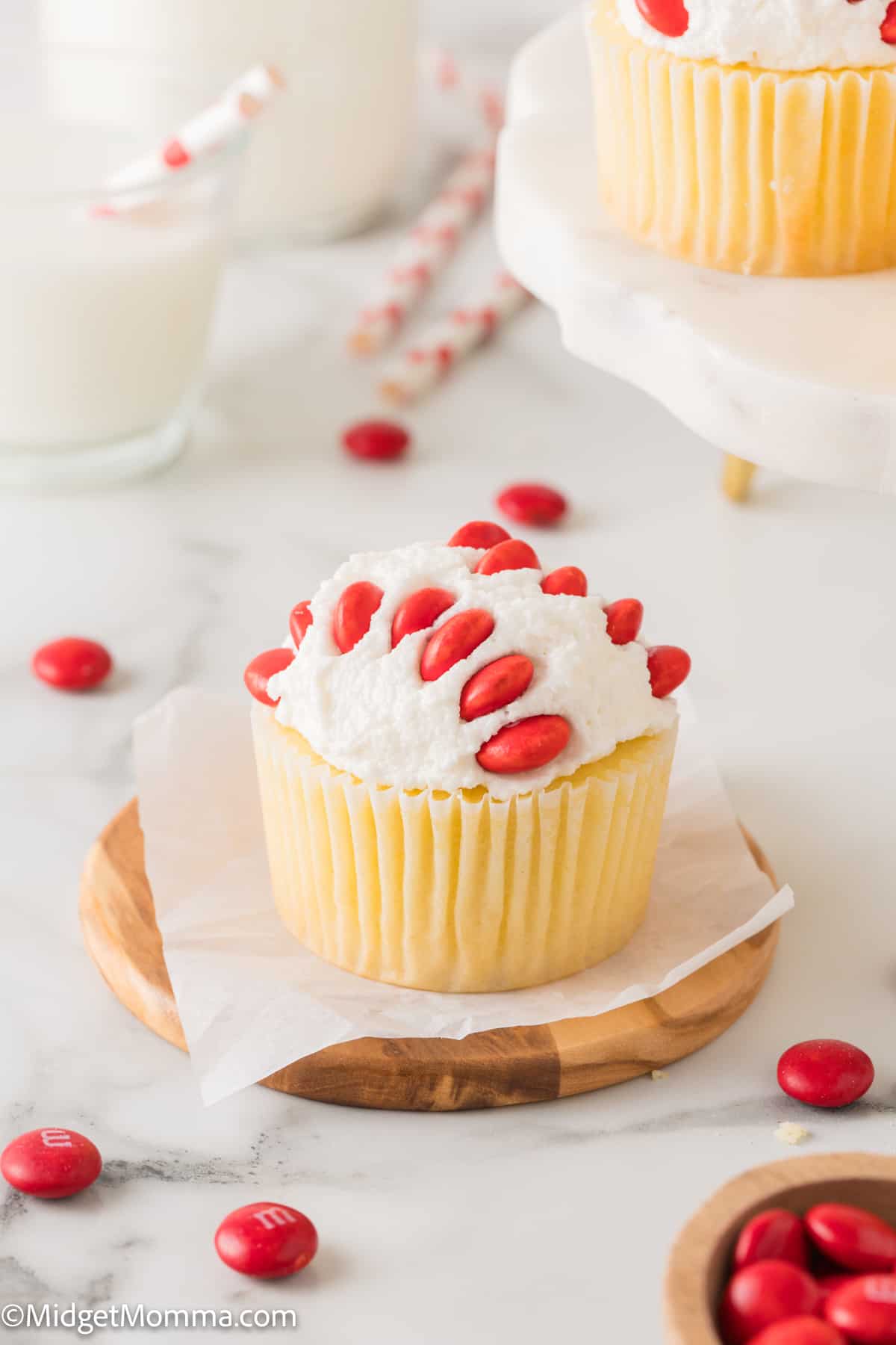 Vanilla cupcake with vanilla buttercream decorated like a baseball