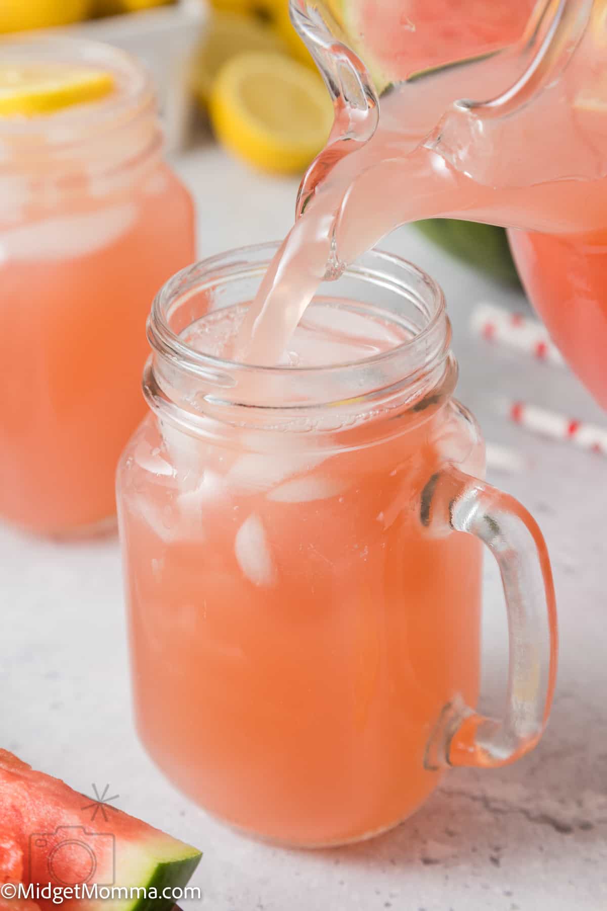 a pitcher pouring a glass of Homemade Watermelon Lemonade 