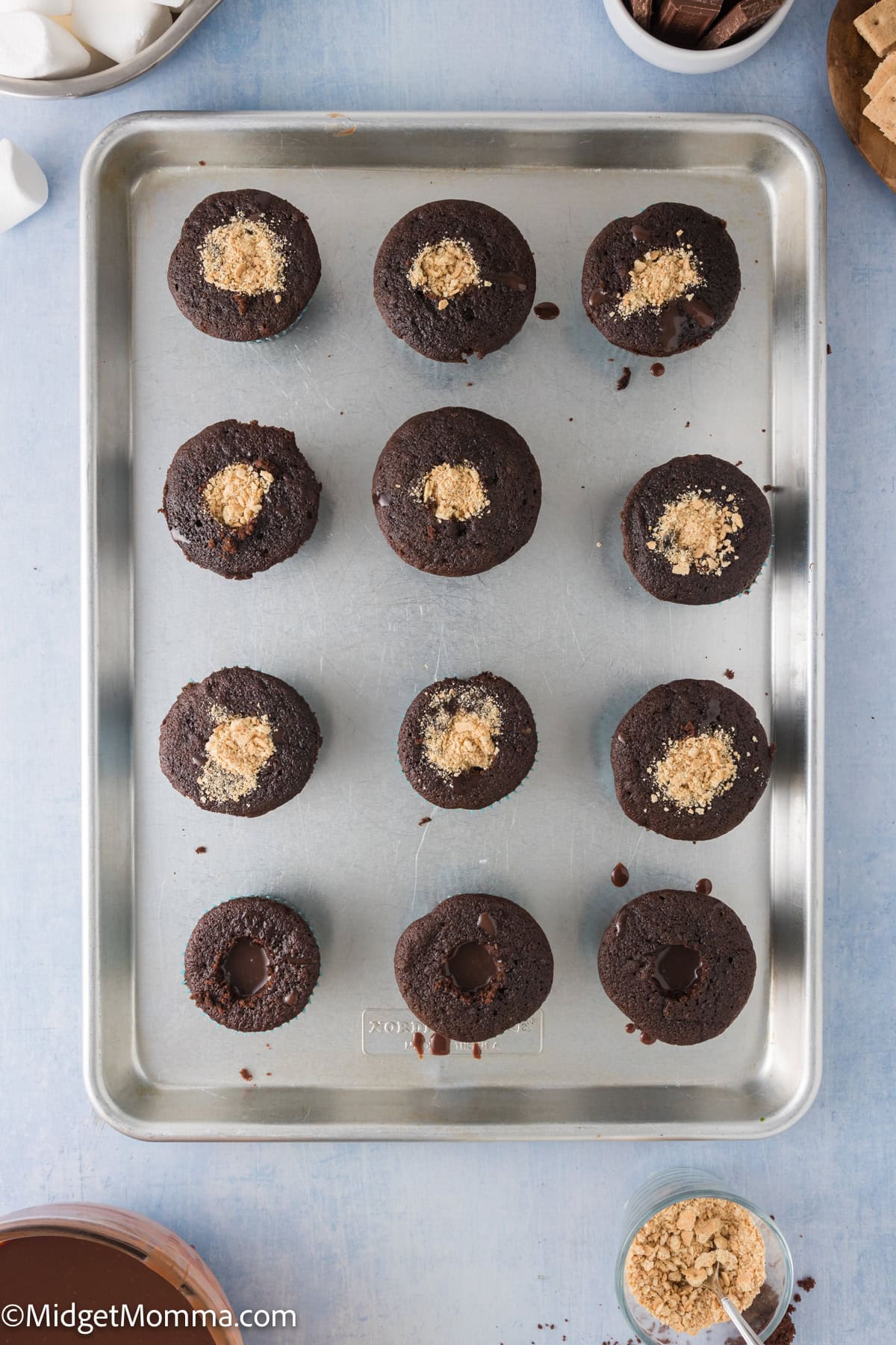 Baked chocolate cupcakes filled with chocolate ganache and graham crackers crumbs.