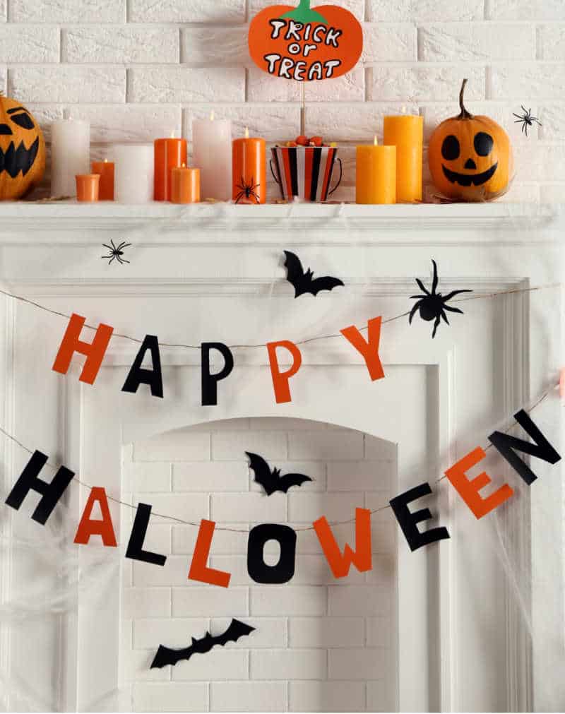 HALLOWEEN PARTY ON A BUDGET- Halloween decorations on white fireplace