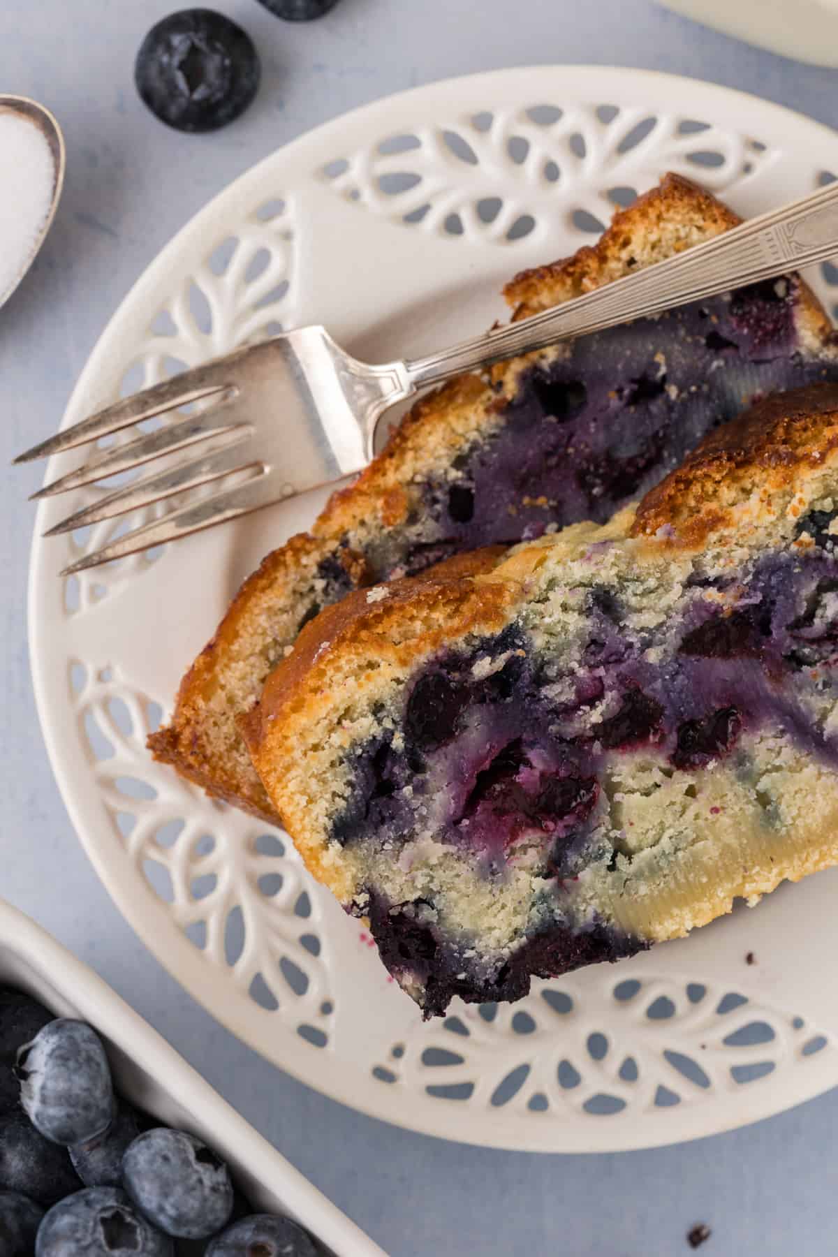 A slice of blueberry bread on a plate.