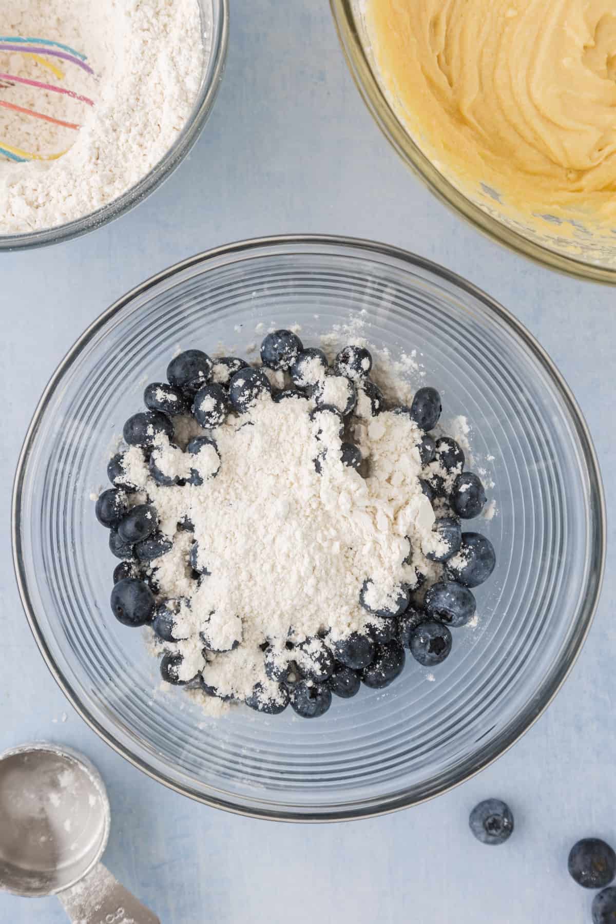 Ingredients for blueberry bread in a bowl on a table.
