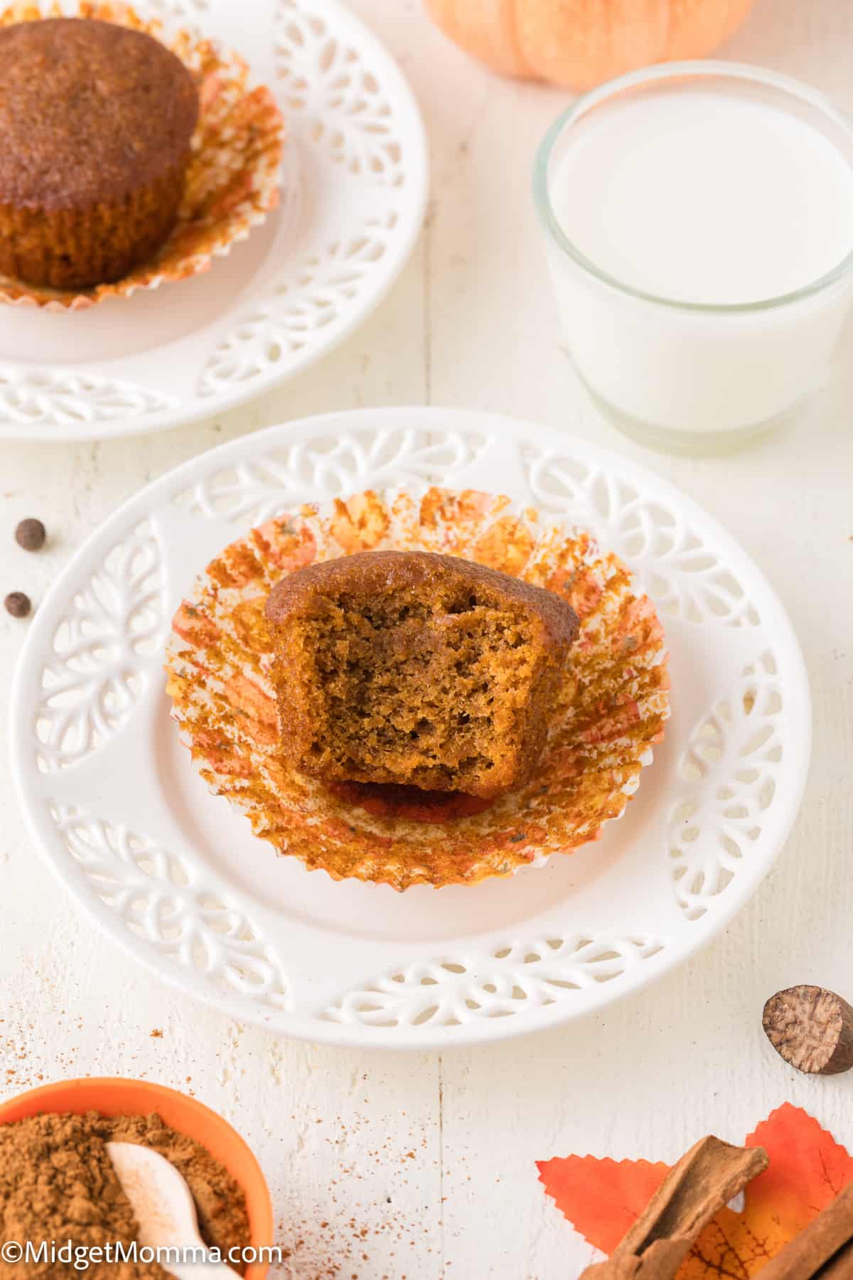 pumpkin muffin with a bite taken out of it on a plate 