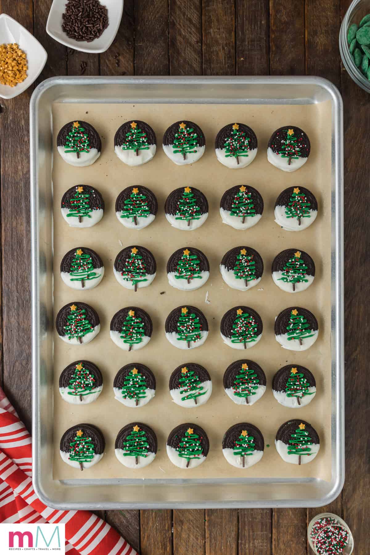 Christmas tree oreos finished being decorated on a baking sheet