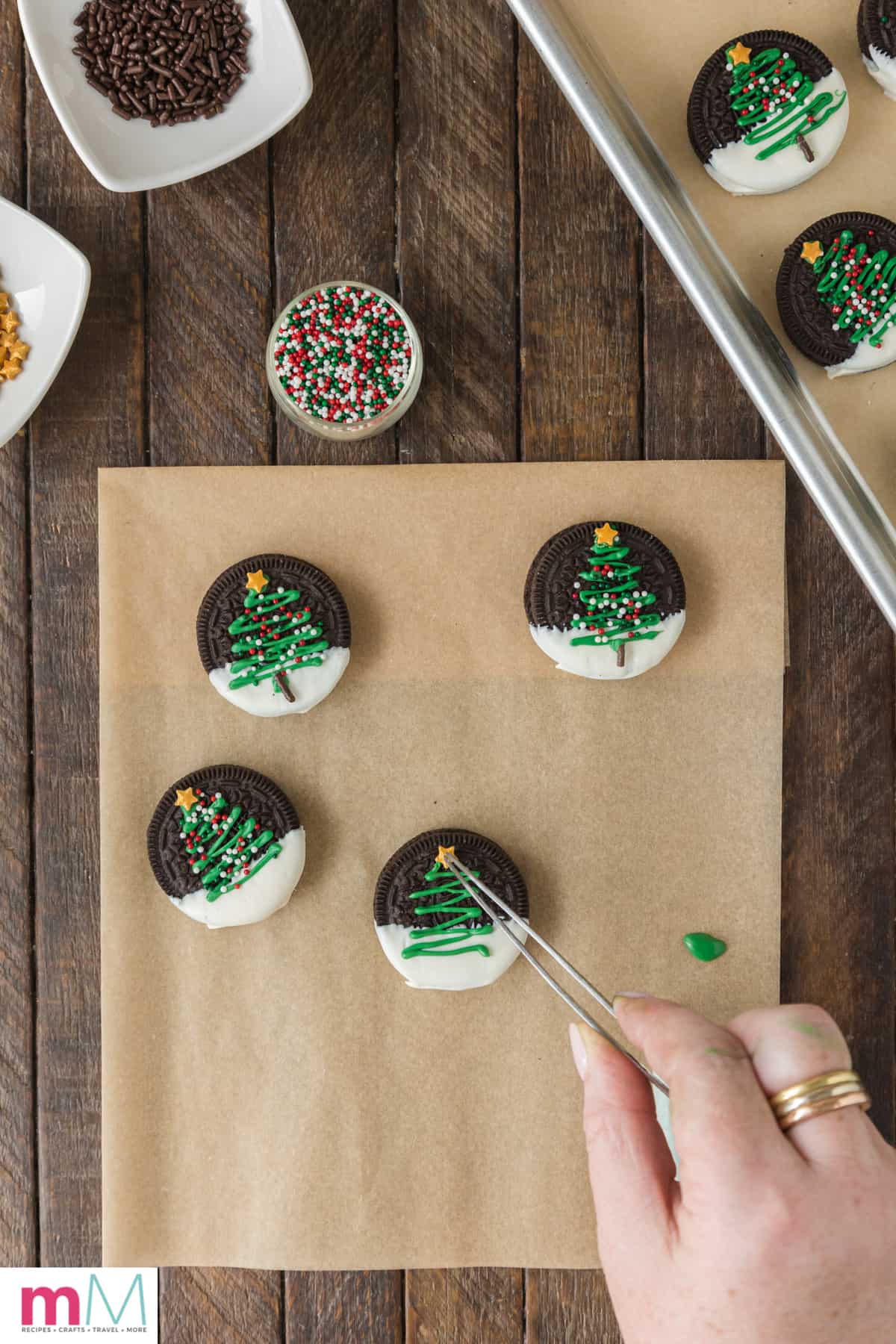 star sprinkle being added to christmas tree oreo cookies
