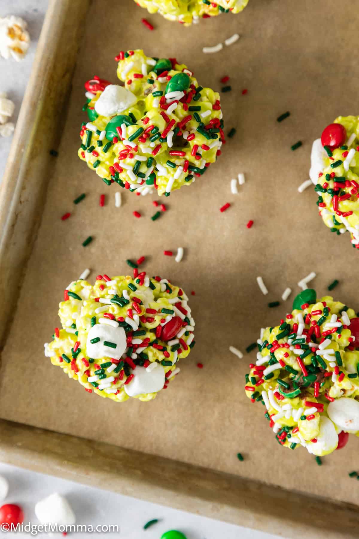 Grinch Marshmallow Popcorn Balls on a baking sheet