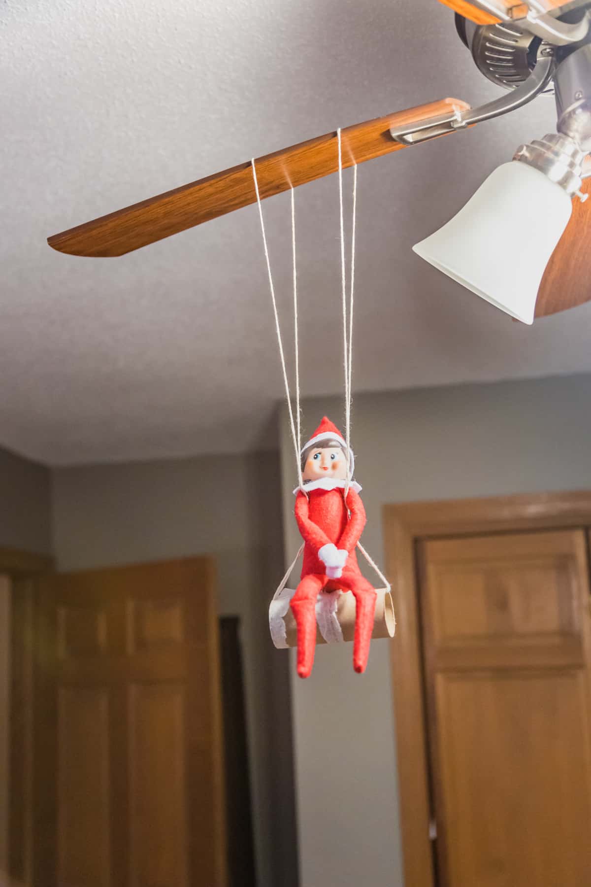 elf on a swing made with a toilet paper roll