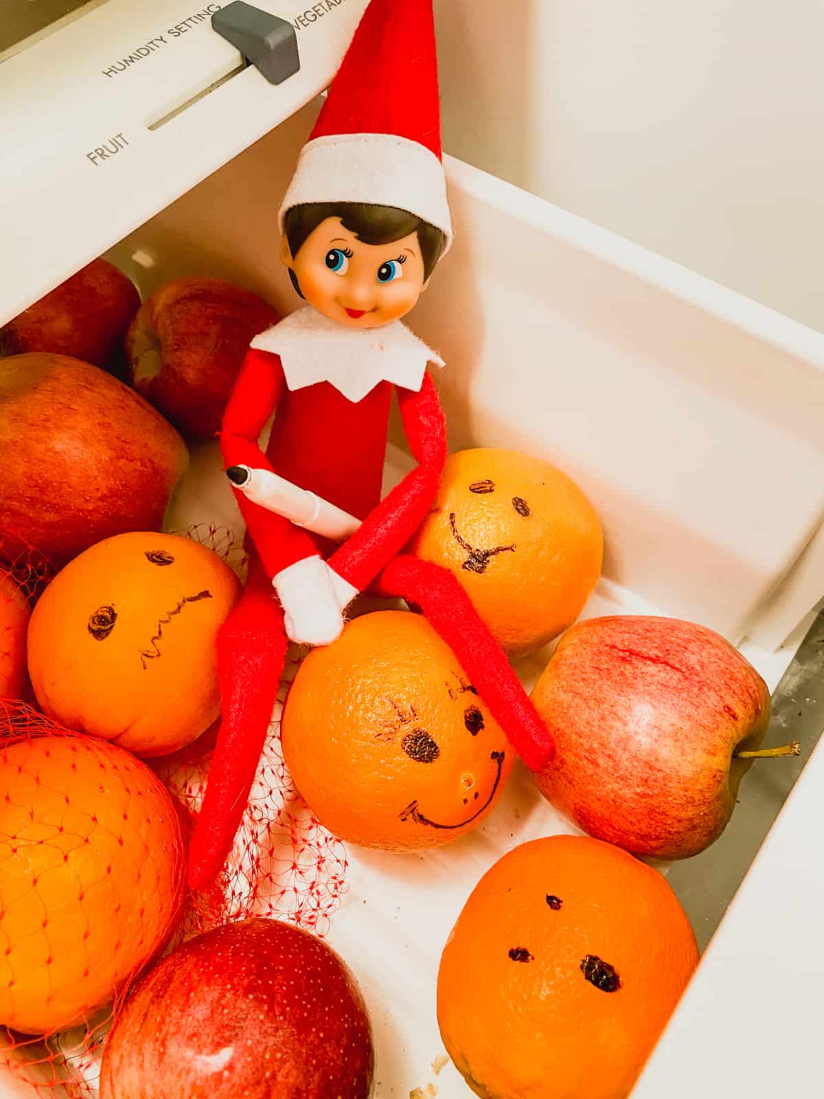 Elf on the shelf with oranges.
