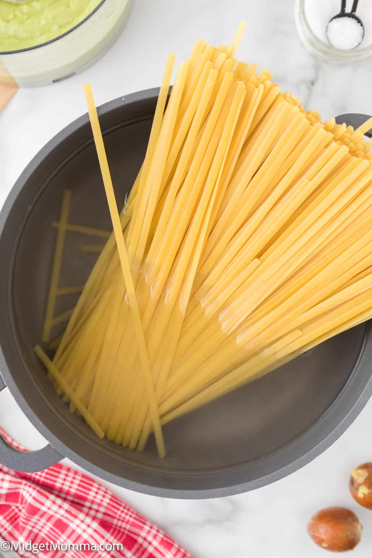 uncooked pasta in a pot of water