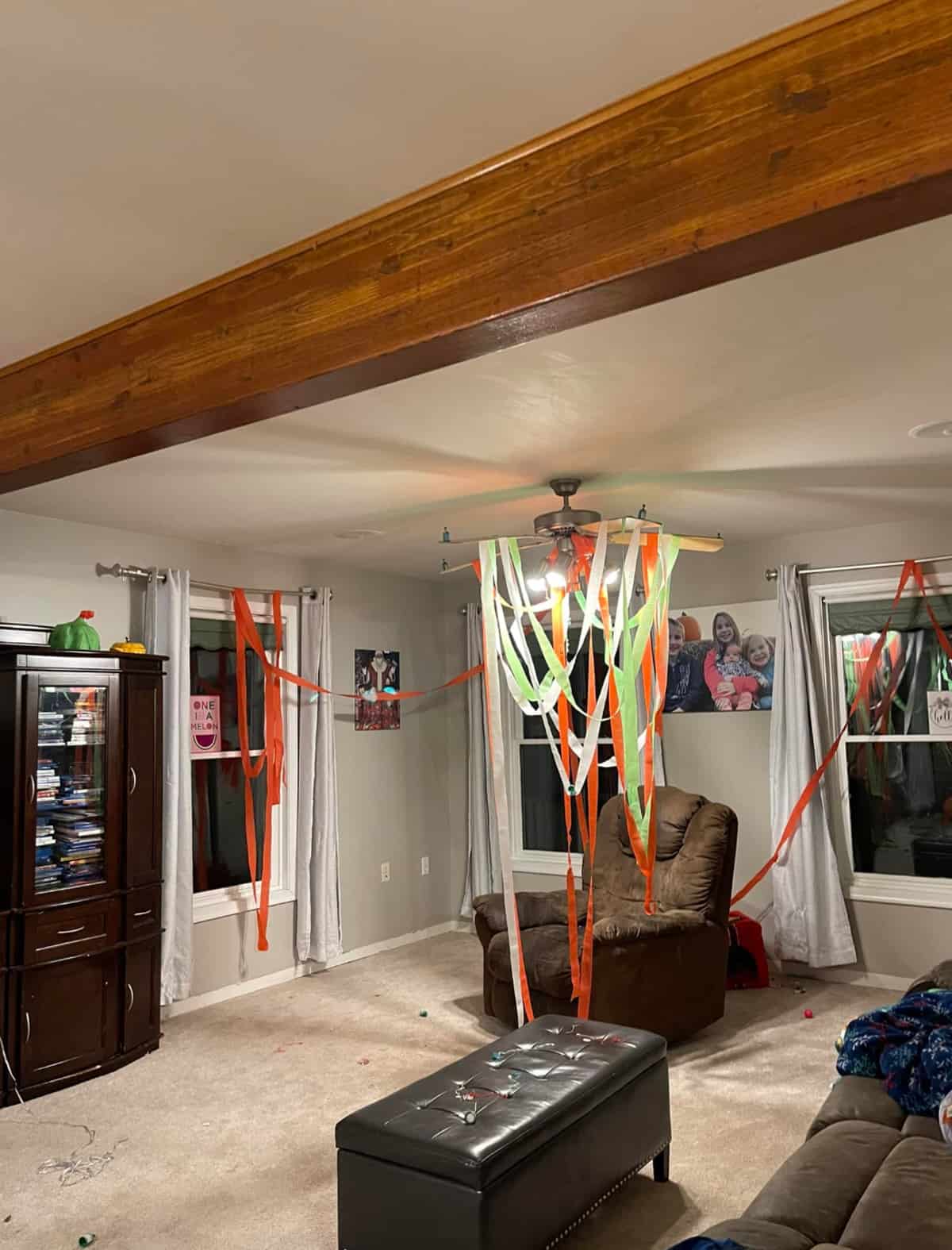 A living room decorated for Christmas Elf arrival with red and green streamers.