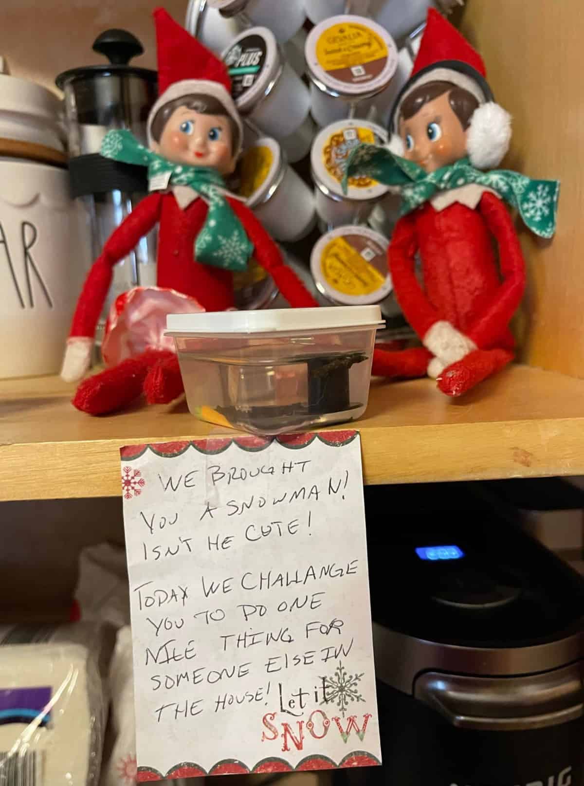 Elf on the shelf sitting on a shelf with a melted snowman