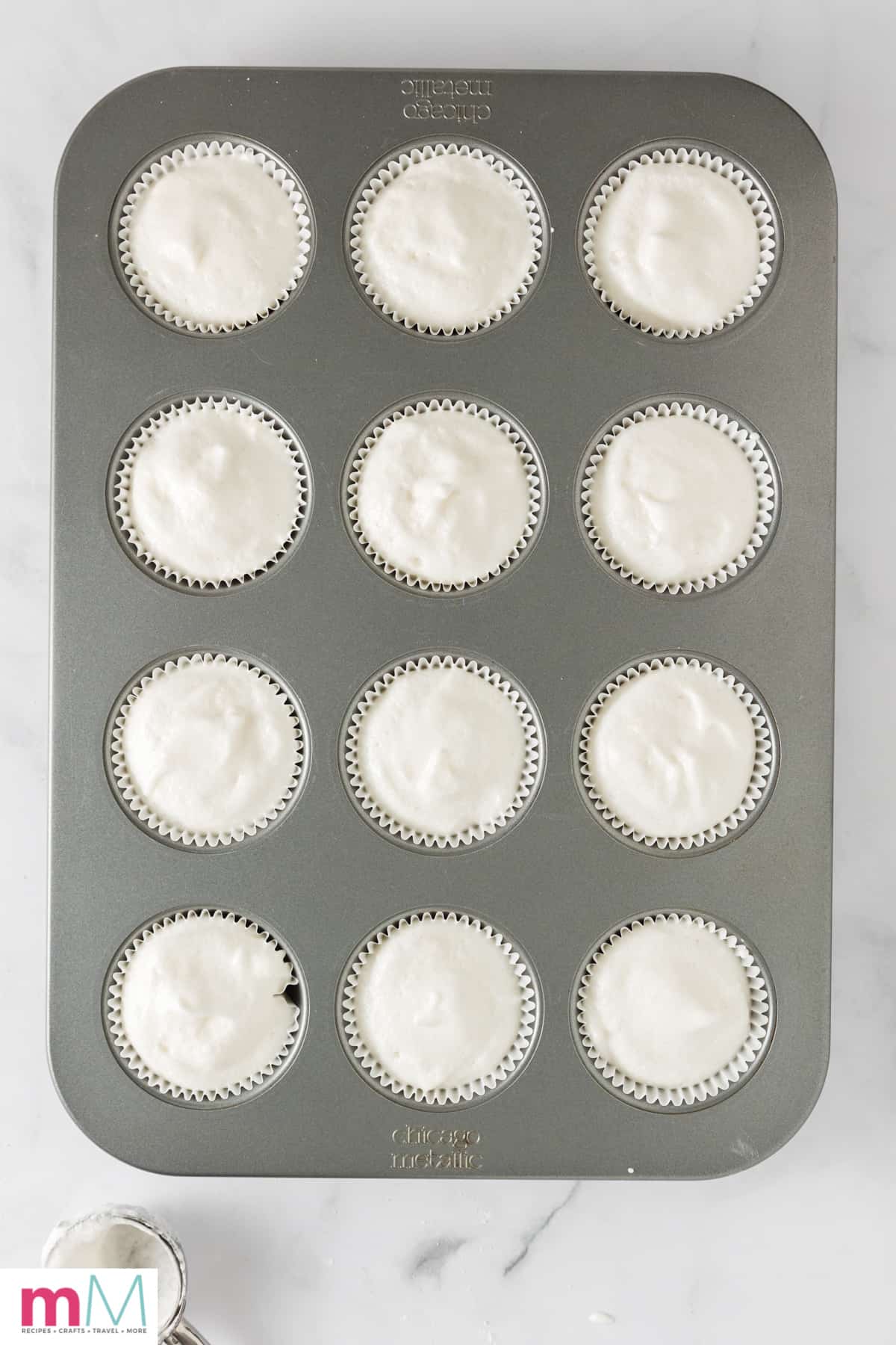 unbaked angel food cake cupcakes batter in cupcake liners in a cupcake pan