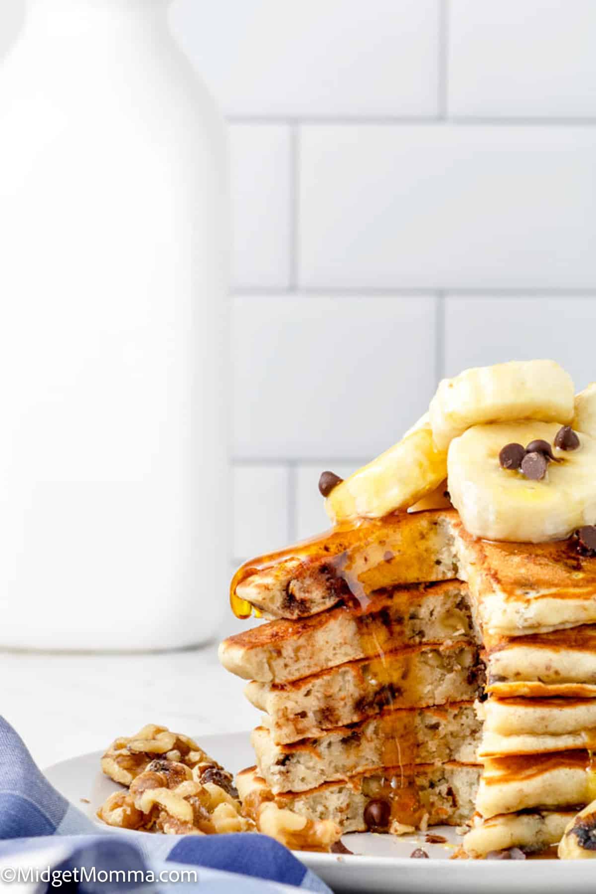 stack of chunky monkey pancakes with a bite taken out of them on a plate