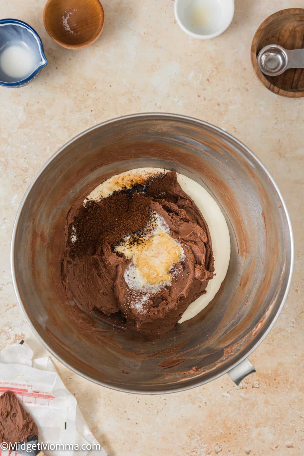 heavy cream, vanilla, salt, and instant coffee powder added to the stand mixer bowl with the fluffy butter mixture. 