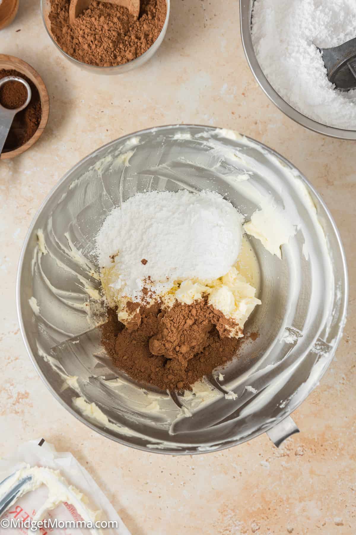 butter, brown sugar, confectioner's sugar and cocoa powder in the bowl of a stand mixer