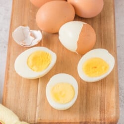 Hard boiled eggs on a cutting board.