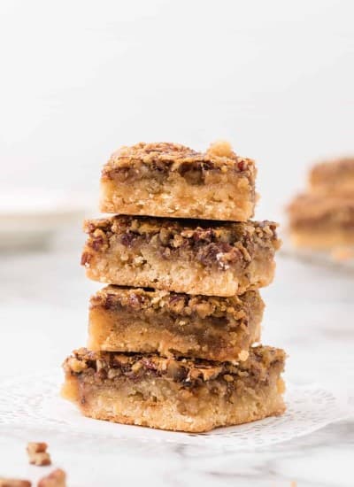 Stack of pecan pie dessert bars on a plate