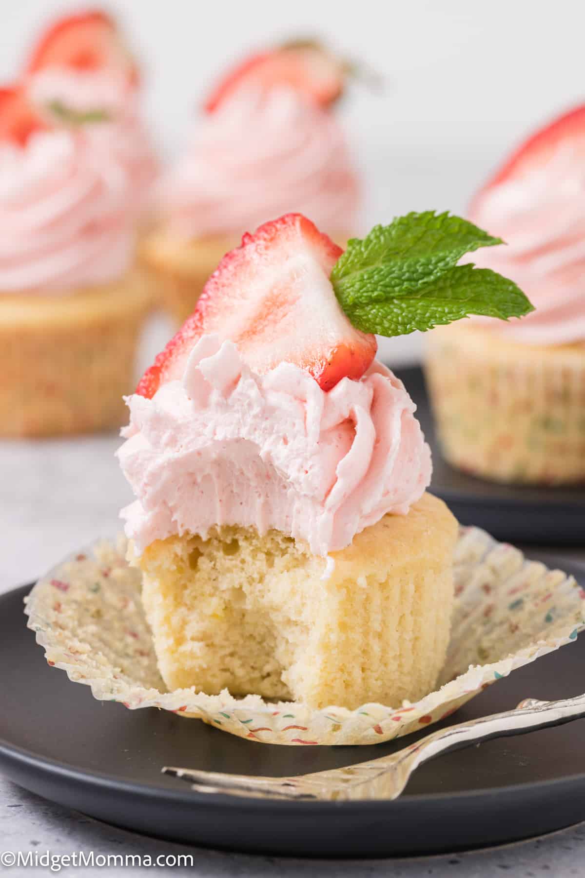 Strawberry cupcake with a bite out of it