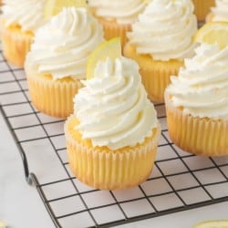 tray of Lemon Cupcakes topped with lemon buttercream frosting and a lemon slice