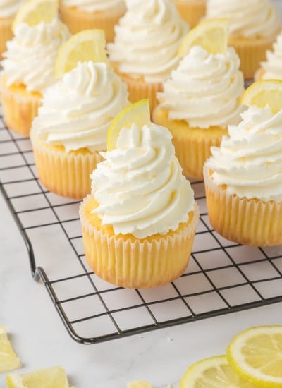 tray of Lemon Cupcakes topped with lemon buttercream frosting and a lemon slice