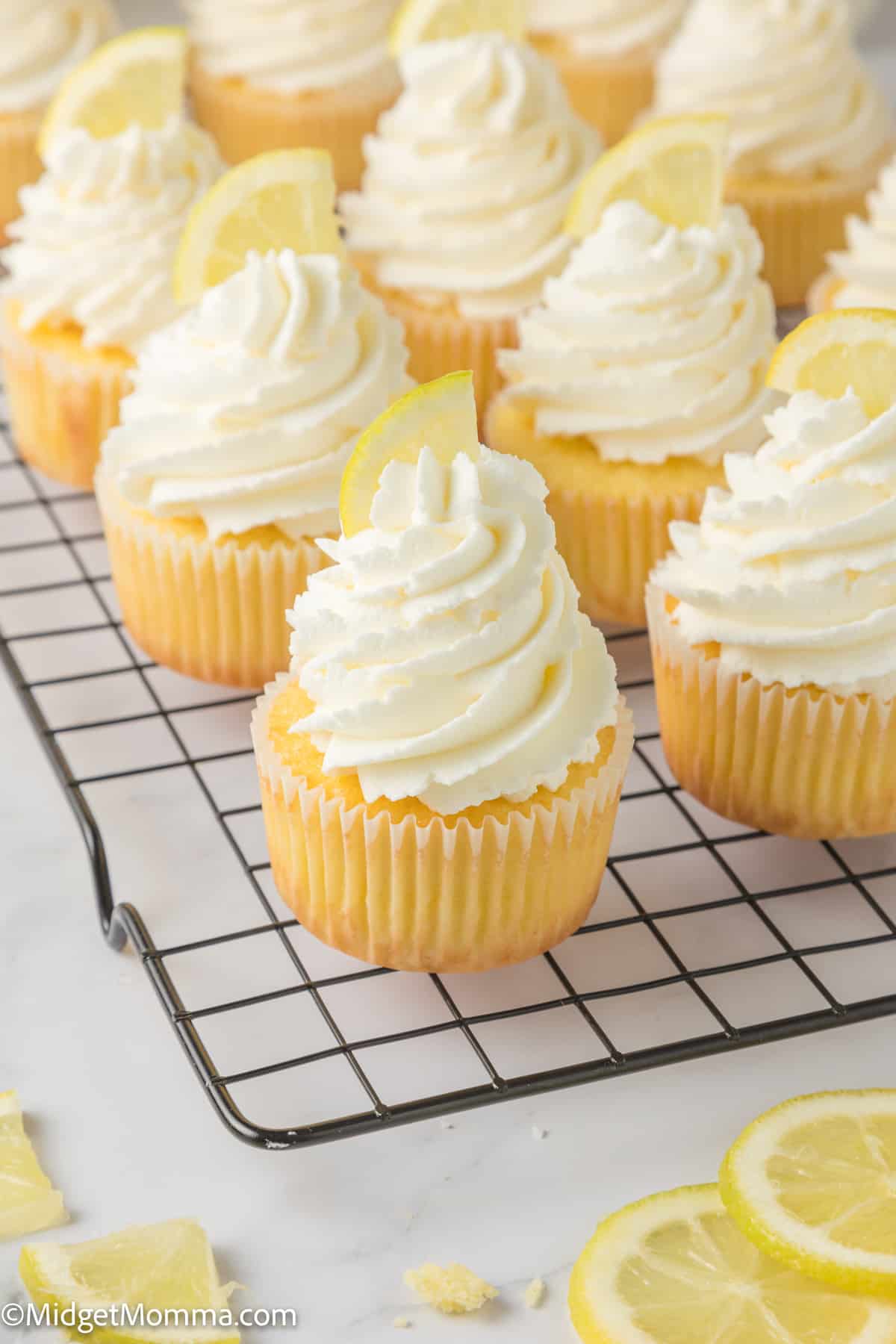 tray of Lemon Cupcakes topped with lemon buttercream frosting and a lemon slice