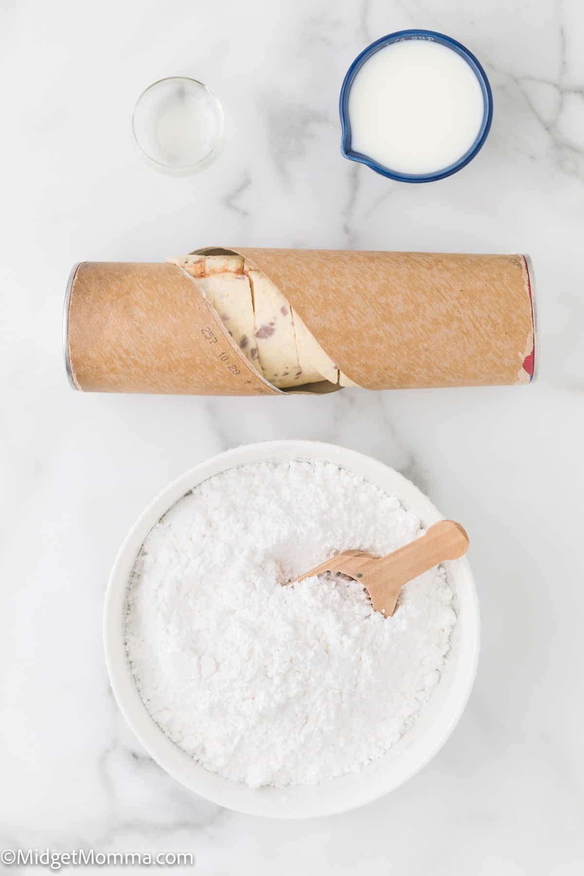 Cinnamon roll waffles ingredients on the counter - milk, cinnamon rolls and powdered sugar