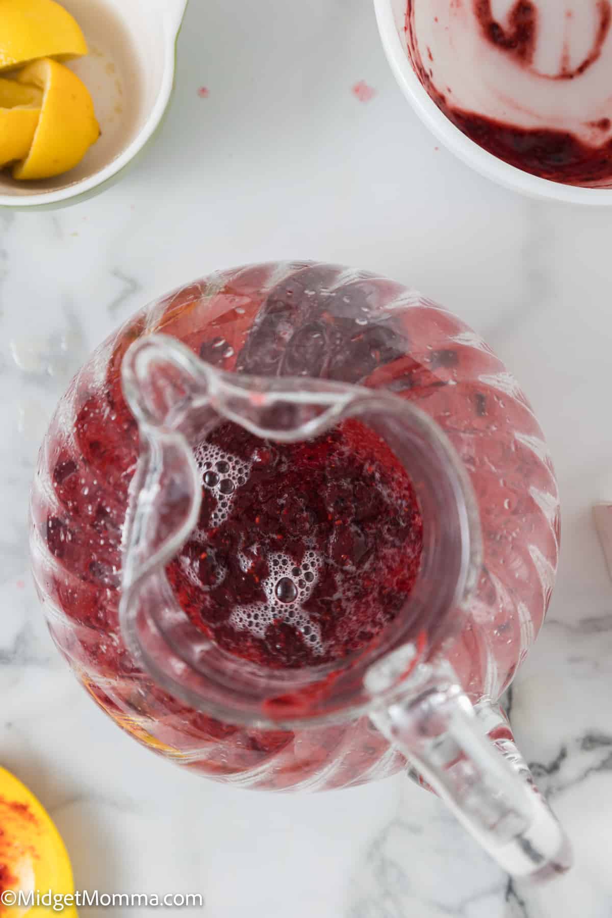 berry puree being added into the lemon juice and water mixture 