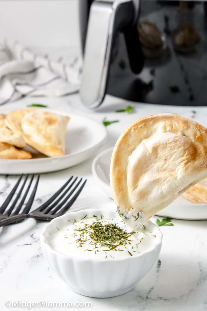 Cooked Air Fryer Perogi being dipped in sauce