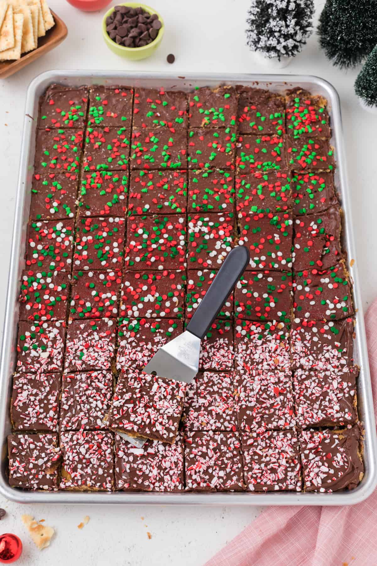 A pan of Saltine Cracker Candy (Christmas Crack) with holiday sprinkles on it.