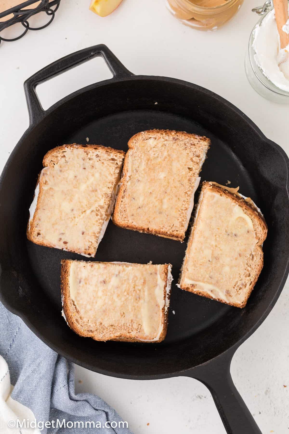 Grilled Peanut Butter and Marshmallow Fluff Sandwich in a pan cooking