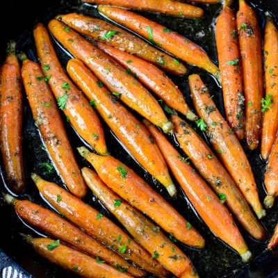 overhead photo of Honey roasted carrots recipe in a cast iron skillet