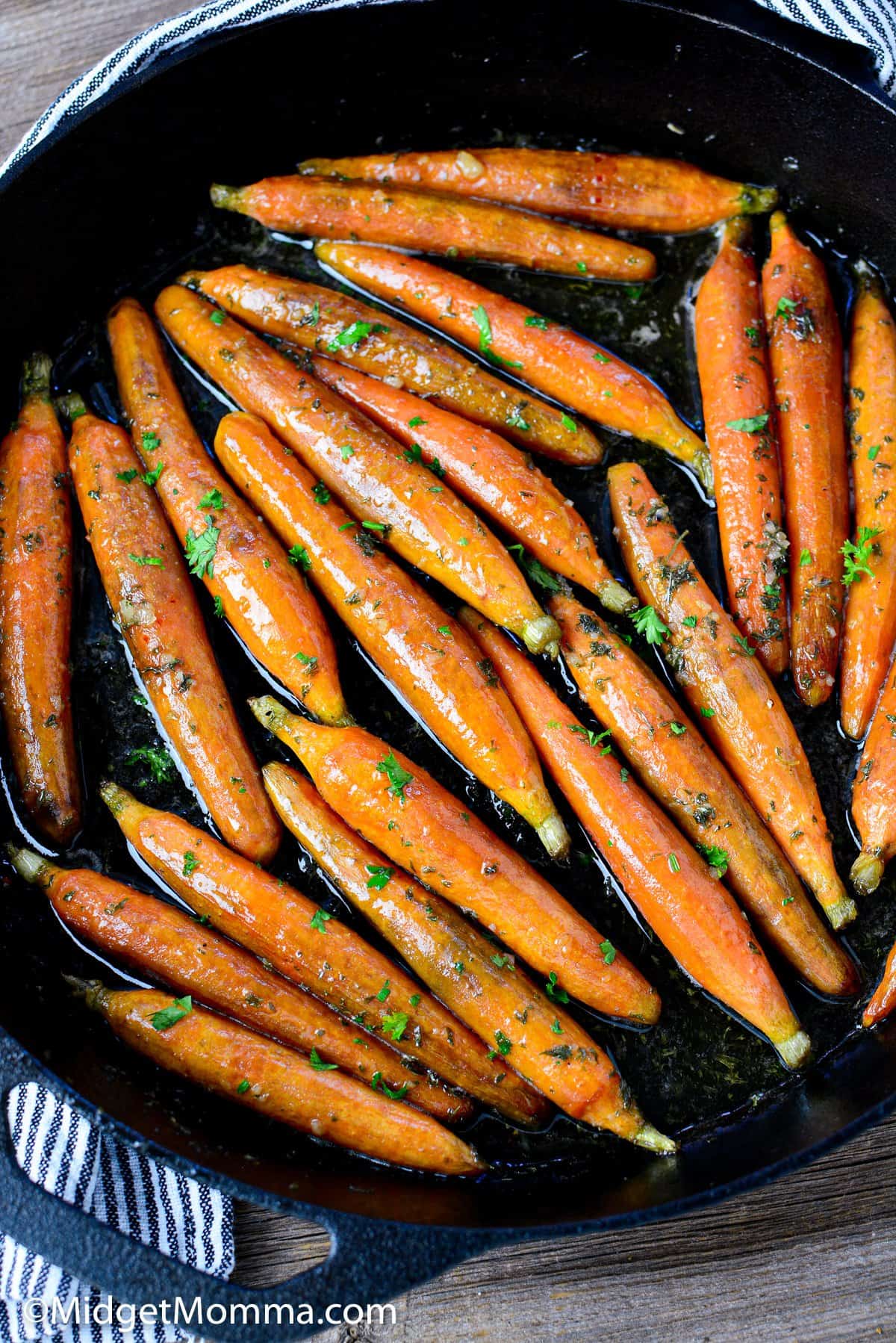 overhead photo of Honey roasted carrots recipe in a cast iron skillet