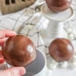 close up photo of hot cocoa bombs in a hand